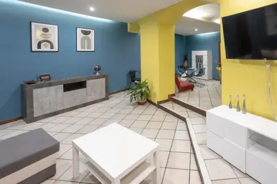 a waiting room with a tv and blue walls at Home Domus Giulio Cesare - Vatican Museum in Rome