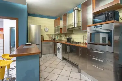 a large kitchen with stainless steel appliances at Home Domus Giulio Cesare - Vatican Museum in Rome