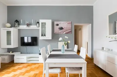 a white dining room with a white table and chairs at Home Domus Giulio Cesare - Vatican Museum in Rome