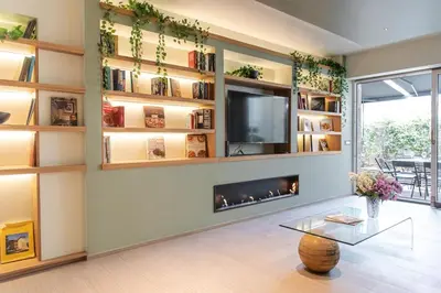 a living room with a fireplace and a tv at Fabiolous suites in Rome