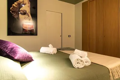 a bedroom with a bed with towels on it at Fabiolous suites in Rome