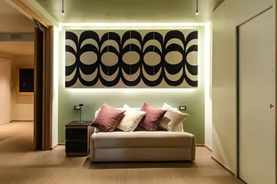 a living room with a couch and a painting on the wall at Fabiolous suites in Rome
