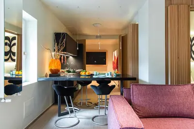 a kitchen with a table and chairs in a room at Fabiolous suites in Rome