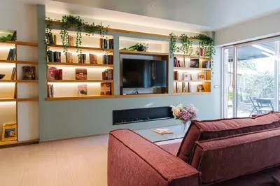 a living room with a couch and a tv at Fabiolous suites in Rome