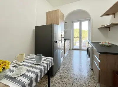 a kitchen with a table and a refrigerator at La Casa di EDY - Metro Malatesta in Rome
