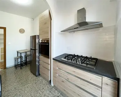 a kitchen with a stove and a refrigerator at La Casa di EDY - Metro Malatesta in Rome