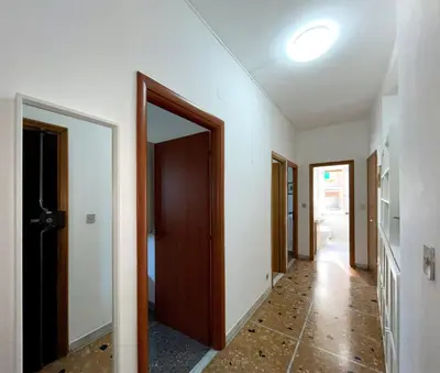 an empty hallway with a door and a mirror at La Casa di EDY - Metro Malatesta in Rome