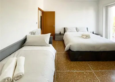 a bedroom with two beds and a window at La Casa di EDY - Metro Malatesta in Rome