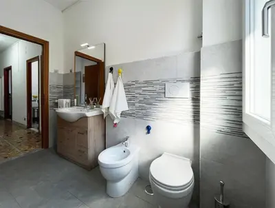 a bathroom with a toilet and a sink and a mirror at La Casa di EDY - Metro Malatesta in Rome