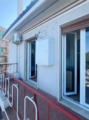 a balcony with two windows and a appliance on it at La Casa di EDY - Metro Malatesta in Rome