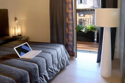 a laptop computer sitting on a bed in a room at Domus Adriani in Rome