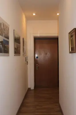 a hallway with a door and a wooden floor at Rome Center Rooms in Rome