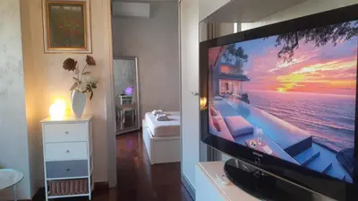 a flat screen tv sitting on a stand in a room at Roma Centro appartamento in Rome