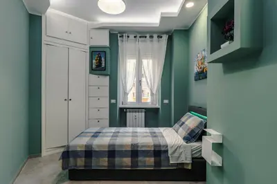 a bedroom with green walls and a bed at OASIS Of PEACE CLOSE TO VATICANO in Rome