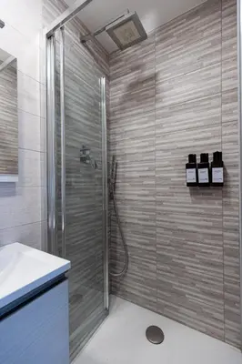 a shower with a glass door in a bathroom at OASIS Of PEACE CLOSE TO VATICANO in Rome