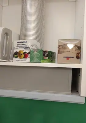 a shelf with some food items on it at OASIS Of PEACE CLOSE TO VATICANO in Rome