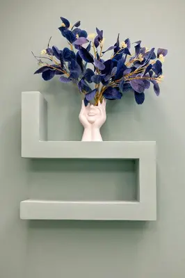 a white vase with purple flowers on a shelf at OASIS Of PEACE CLOSE TO VATICANO in Rome