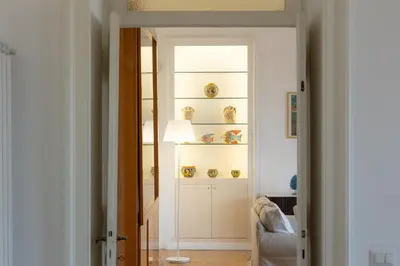 a room with a door with a shelf with vases at Amazing Piazza Fiume in Rome