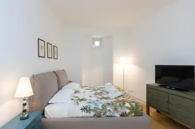 a bedroom with a bed and a flat screen tv at Amazing Piazza Fiume in Rome