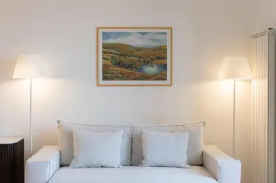 a white couch in a room with two lamps at Amazing Piazza Fiume in Rome