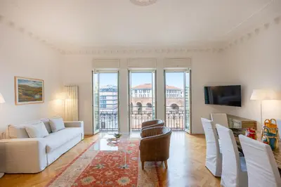 a living room with a white couch and a tv at Amazing Piazza Fiume in Rome