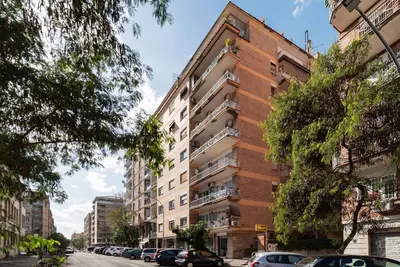 an apartment building on a street with parked cars at GuestHost - Garbatella Comfy Apartment in Rome