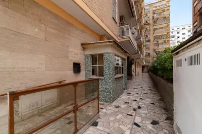 an empty alley in a city with buildings at GuestHost - Garbatella Comfy Apartment in Rome