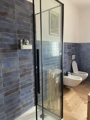 a glass shower in a bathroom with a toilet at la casa di Janis in Rome
