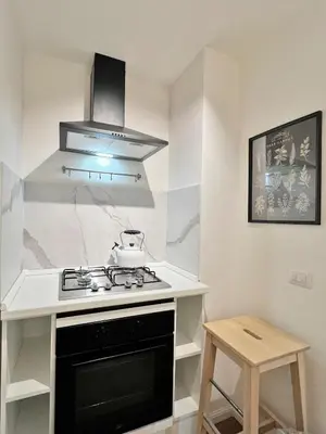 a kitchen with a stove and a counter top at Roma Parioli - Manfredi Suites appartamento in Rome
