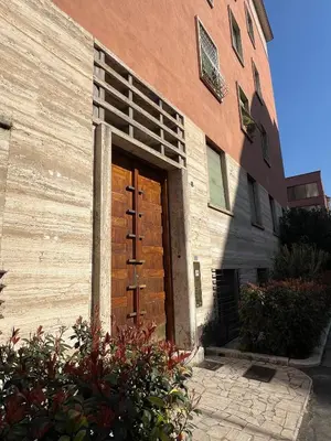 a wooden door on the side of a building at Roma Parioli - Manfredi Suites appartamento in Rome