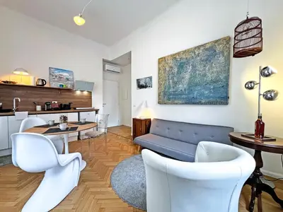 a living room with a couch and a table and chairs at Roma Parioli - Manfredi Suites appartamento in Rome