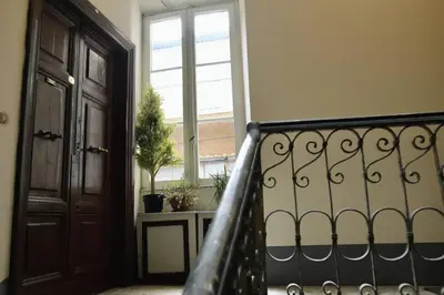 a hallway with a staircase with a door and a window at The 150 Home - Homkeey Apartments in Rome