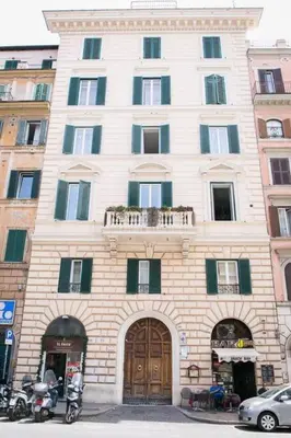 a large white building with a balcony on top of it at The 150 Home - Homkeey Apartments in Rome