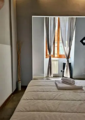 a bedroom with a large bed with a window at The 150 Home - Homkeey Apartments in Rome