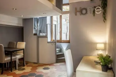 a living room with a table and a dining room at The 150 Home - Homkeey Apartments in Rome