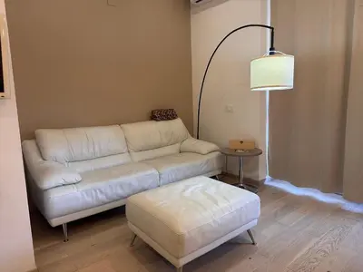 a living room with a couch and a table at Monolocale San Giovanni con Balcone a 50 m dalla metro in Rome