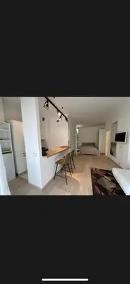 a room with a bed and a table and chairs at Monolocale San Giovanni con Balcone a 50 m dalla metro in Rome