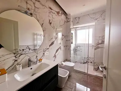 a bathroom with a sink and a toilet and a shower at Upper San Pietro elegant flat on metro A with a view in Rome