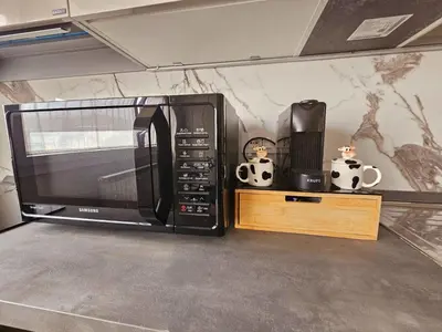 a microwave oven sitting on top of a table at Upper San Pietro elegant flat on metro A with a view in Rome