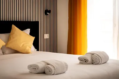 a bedroom with a bed with towels on it at Upper San Pietro elegant flat on metro A with a view in Rome