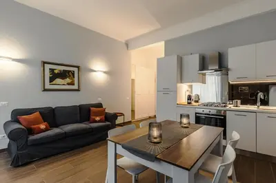 a living room with a couch and a table at 2-Bedroom Roman Gem in Rome