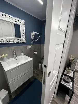 a bathroom with a white sink and a mirror at Leopardi House 3 in Rome