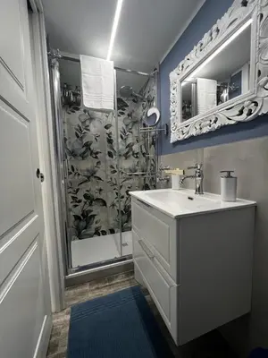 a bathroom with a sink and a shower at Leopardi House 3 in Rome