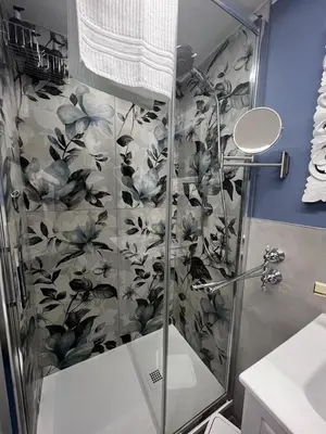 a bathroom with a shower with a glass door at Leopardi House 3 in Rome