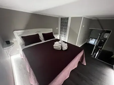 a bedroom with a large bed with two towels on it at Leopardi House 3 in Rome