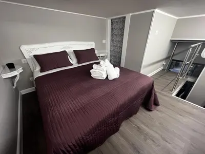a bedroom with a large bed with towels on it at Leopardi House 3 in Rome