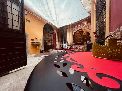 a room with a red carpet and a table at Leopardi House 3 in Rome