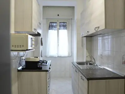 a kitchen with a sink and a microwave at Triade Home in Rome