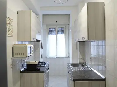 a kitchen with a stove and a microwave in it at Triade Home in Rome
