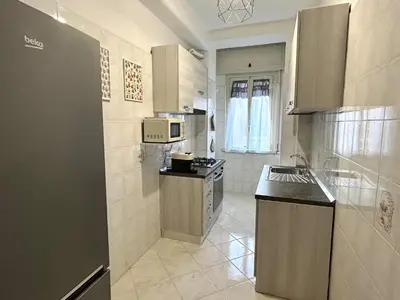 a small kitchen with a sink and a microwave at Triade Home in Rome